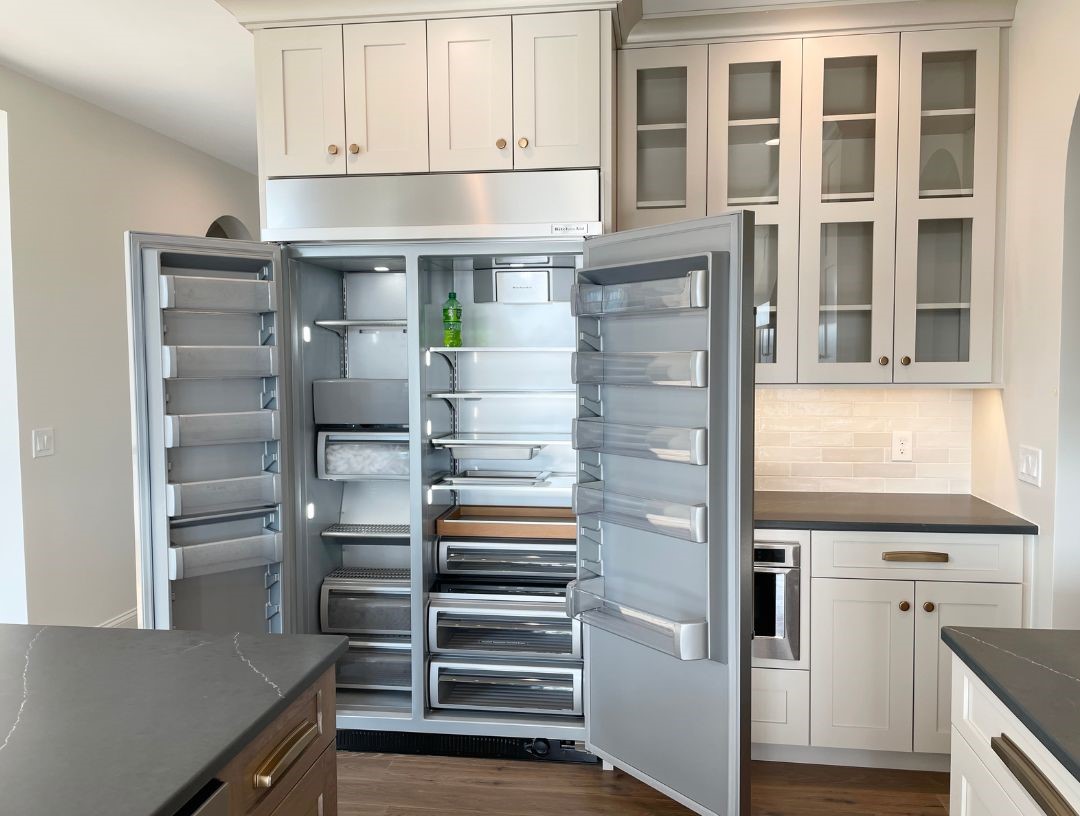 side by side built in refrigerator in kitchen shown with both doors open