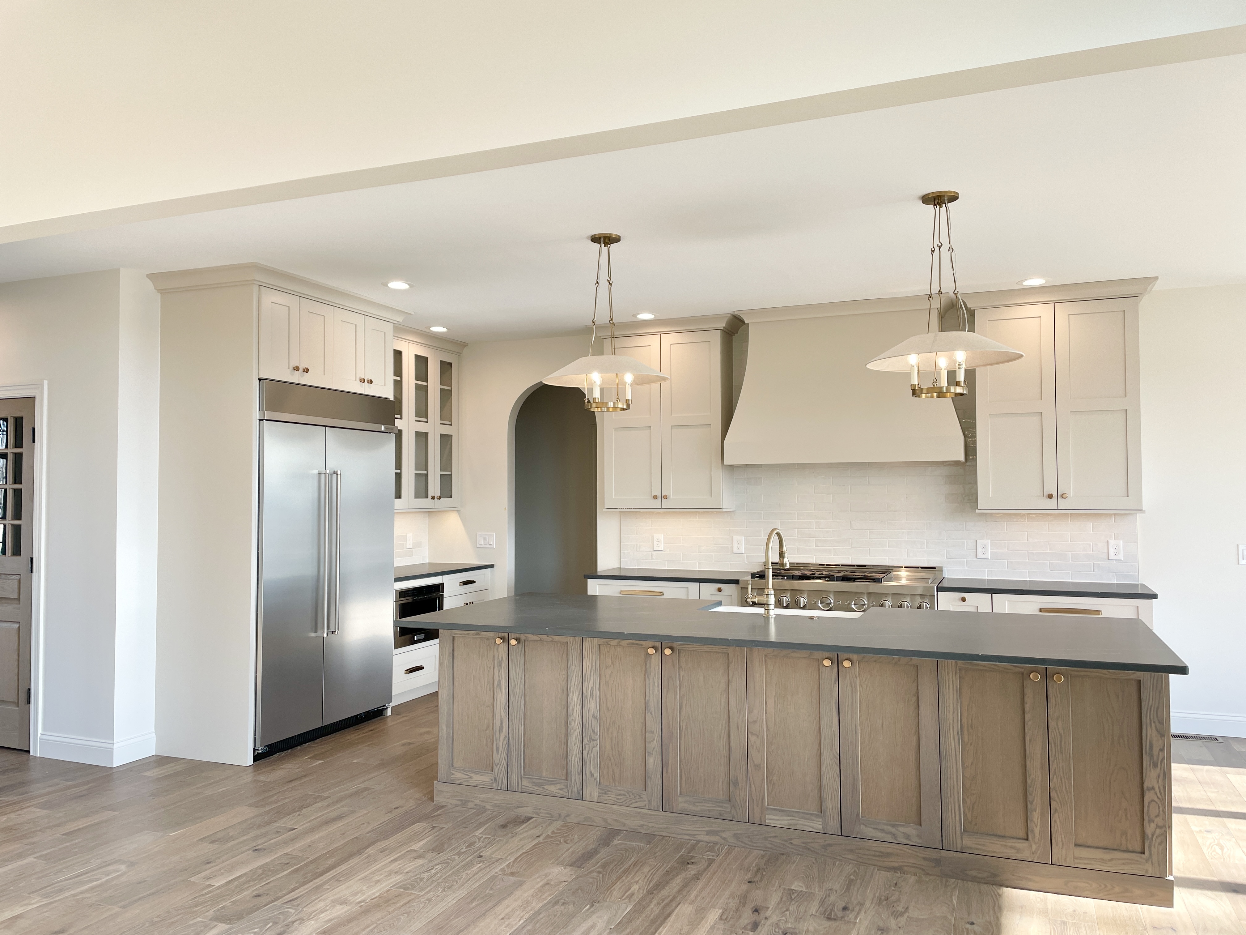 village home stores kitchen design with white oak island and painted white cabinets