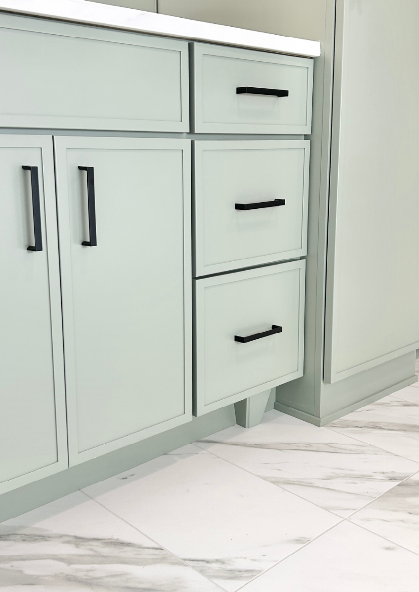 light green painted vanity cabinets with decorative foot added in toekick space
