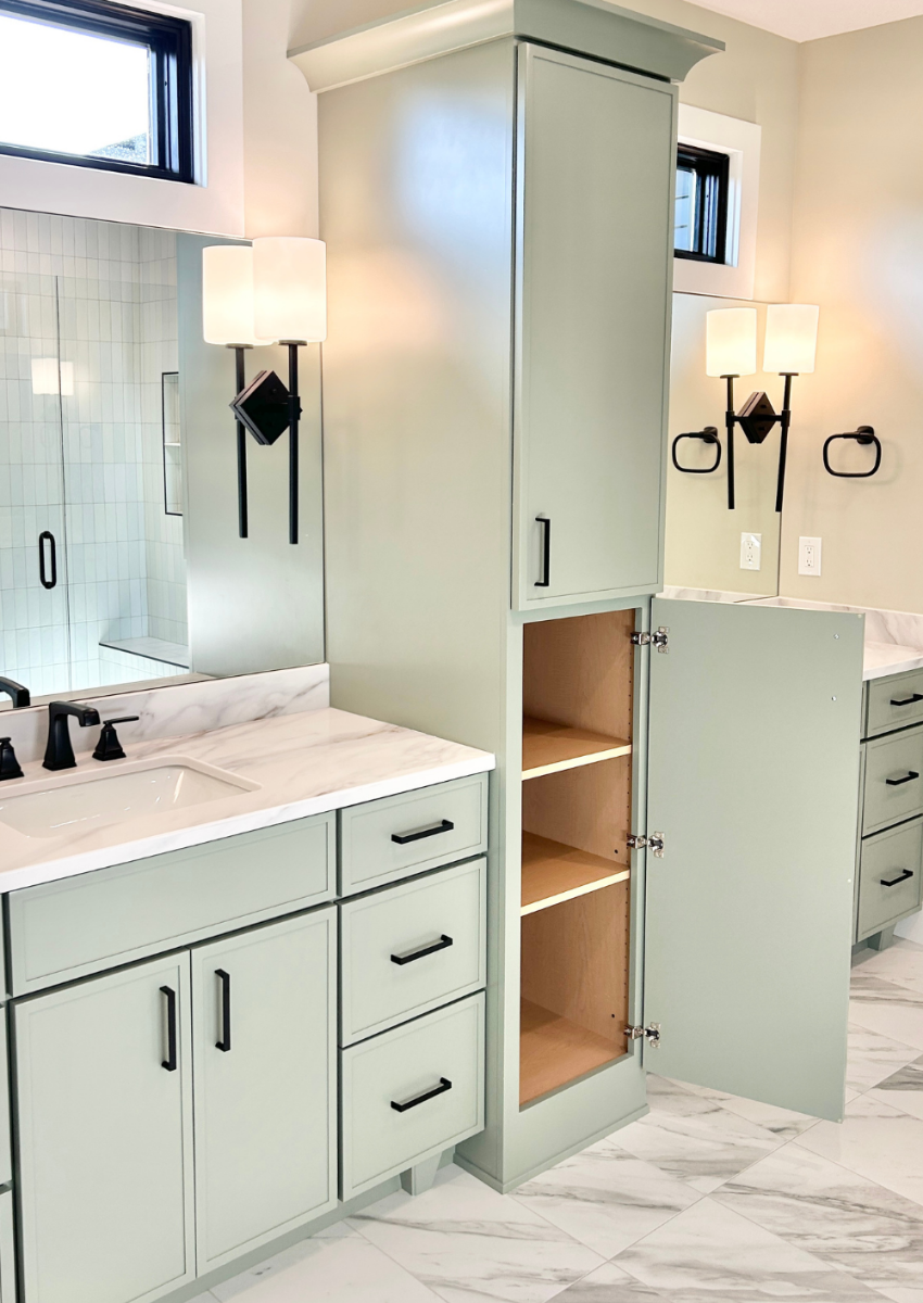 bathroom vanities in evergreen fog green painted finish with linen tower at center