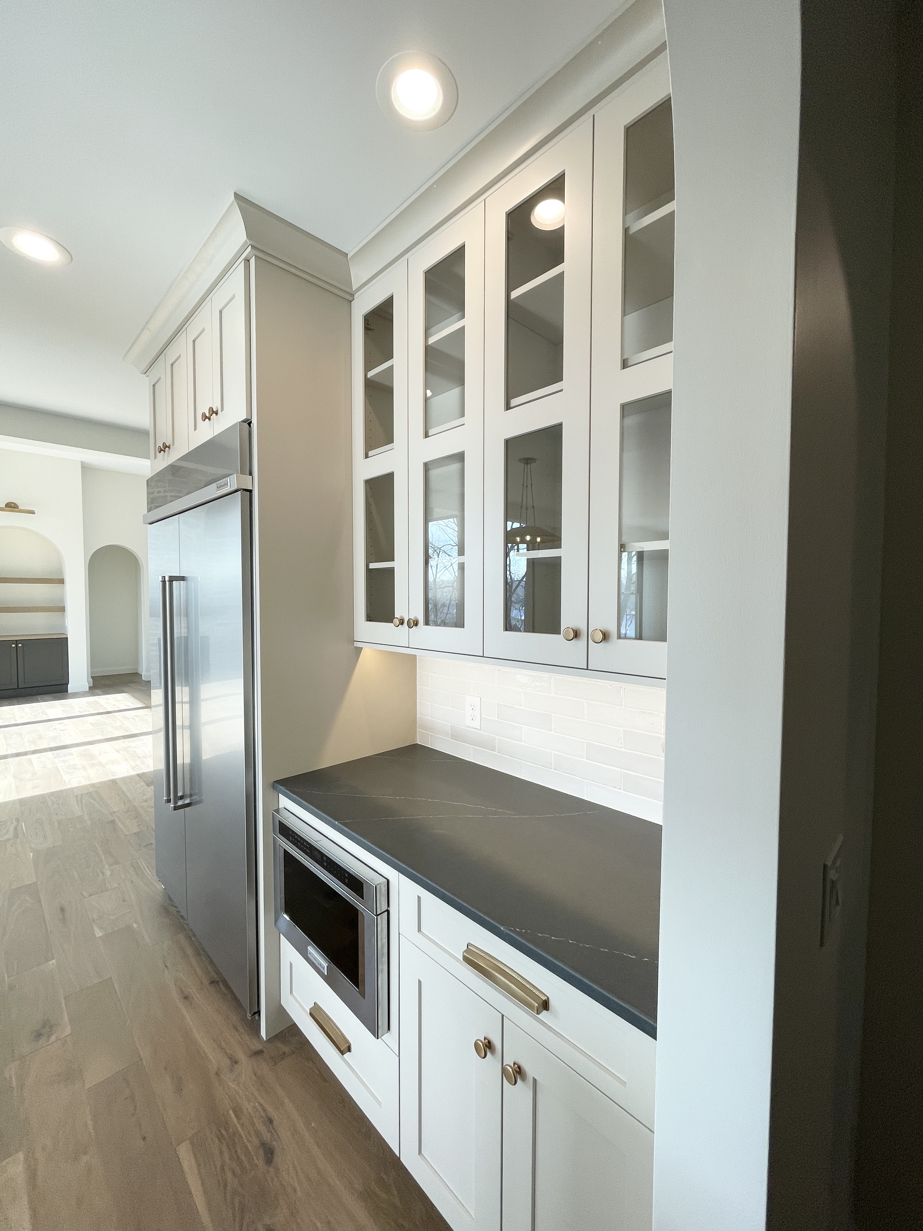 Wynnbrooke cabinetry in Accessible Beige painted finish installed with Soapstone Metropolis quartz counters in a Bettendorf, Iowa home.