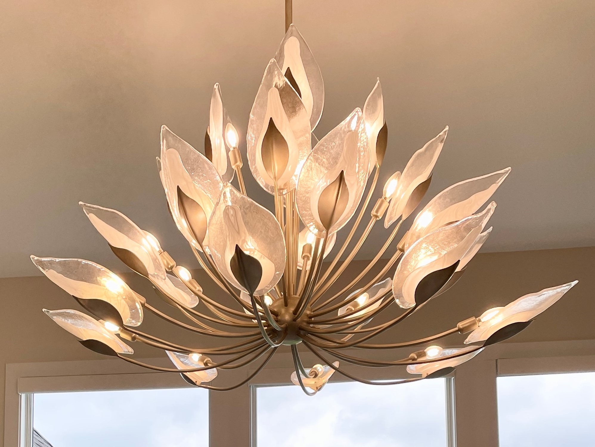 Biophilic Luxe Hudson Valley 28-light chandelier hanging in a Quad Cities home. Lighting by Village Home Stores.