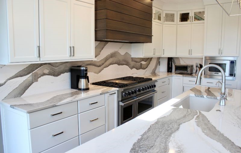 Skara Brae Cambria Quartz countertops and full-height backsplash installed in a Bettendorf, Iowa kitchen remodeled by Village Home Stores.