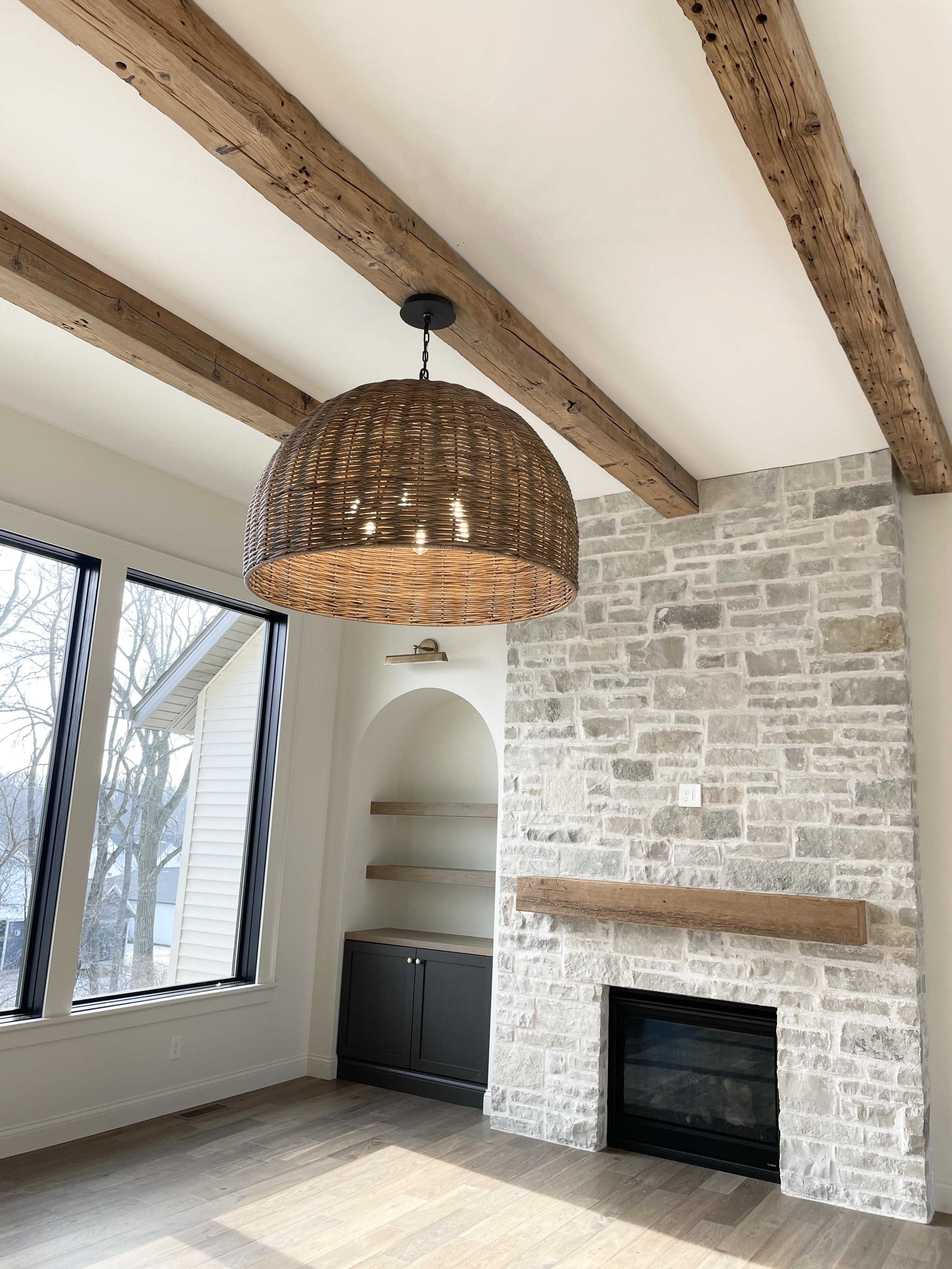 Huxley rattan chandelier by Troy Lighting from Village Home Stores hanging in the great room of a Bettendorf, Iowa home by Aspen Homes.