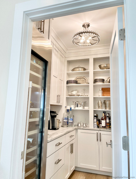 walk in kitchen pantry with glass door wine cooler, white cabinetry, and open shelves