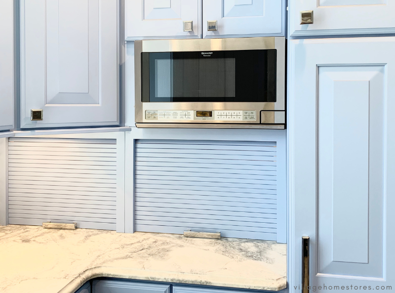  blue cabinet kitchen with over counter microwave and two appliance garage cabinets down to counter