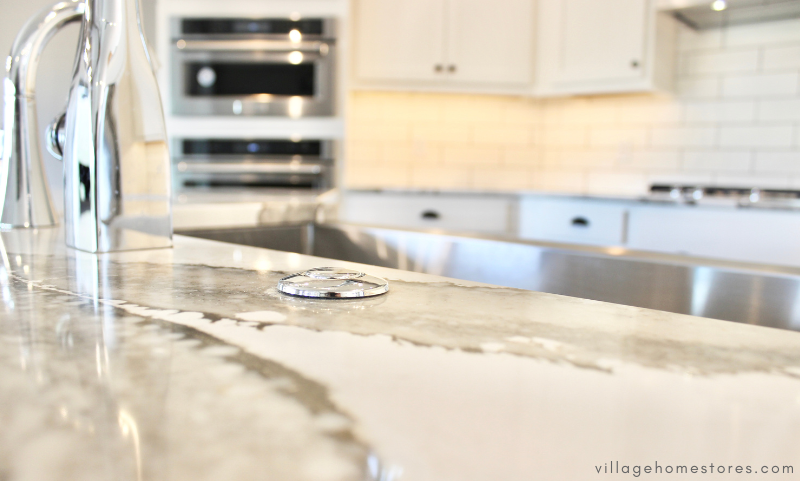 close up shot of chrome garbage disposal button installed on kitchen countertop