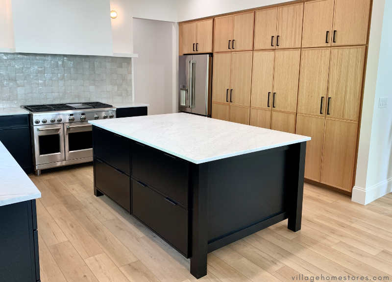 kitchen with black painted kitchen island at center
