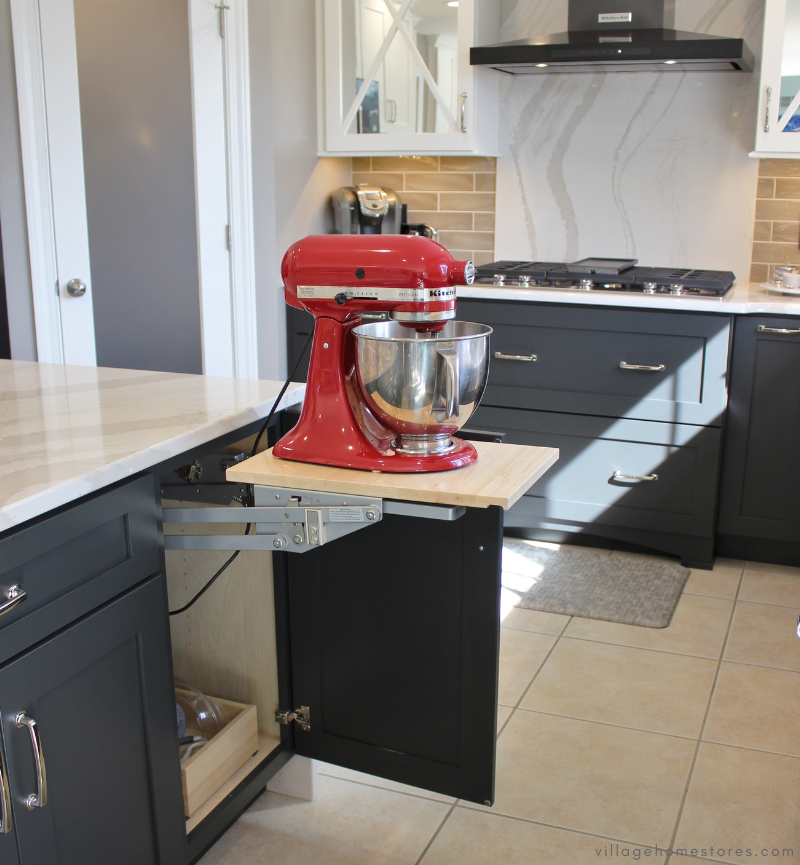 kitchen island cabinet with door open to reveal lift up mixer lift shelf with red kitchenaid stand mixer on it