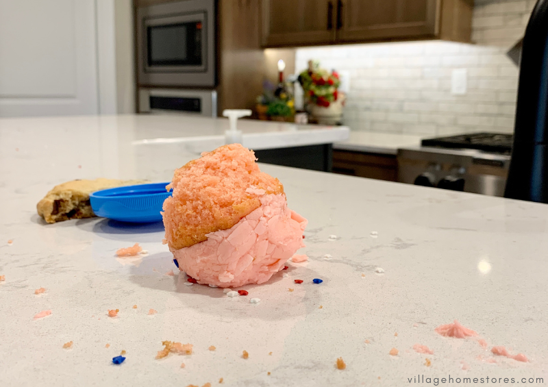 white quartz countertop with upside down pink frosted cupcake and sprinkles on surface