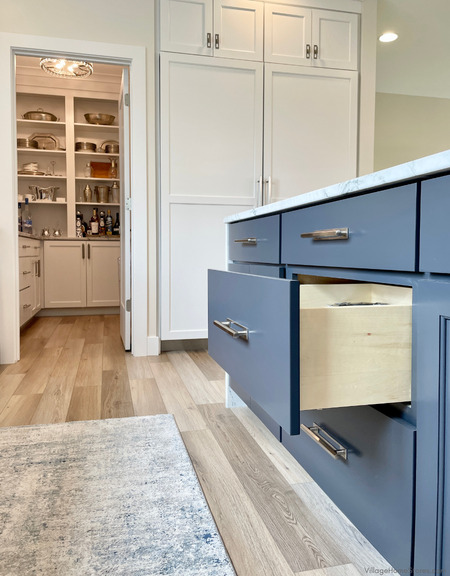 close up of blue painted kitchen Koch cabinets with one drawer open