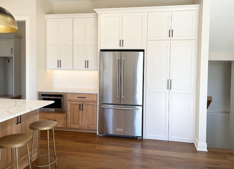 village home stores kitchen design with ivory white cabinets and stainless appliances