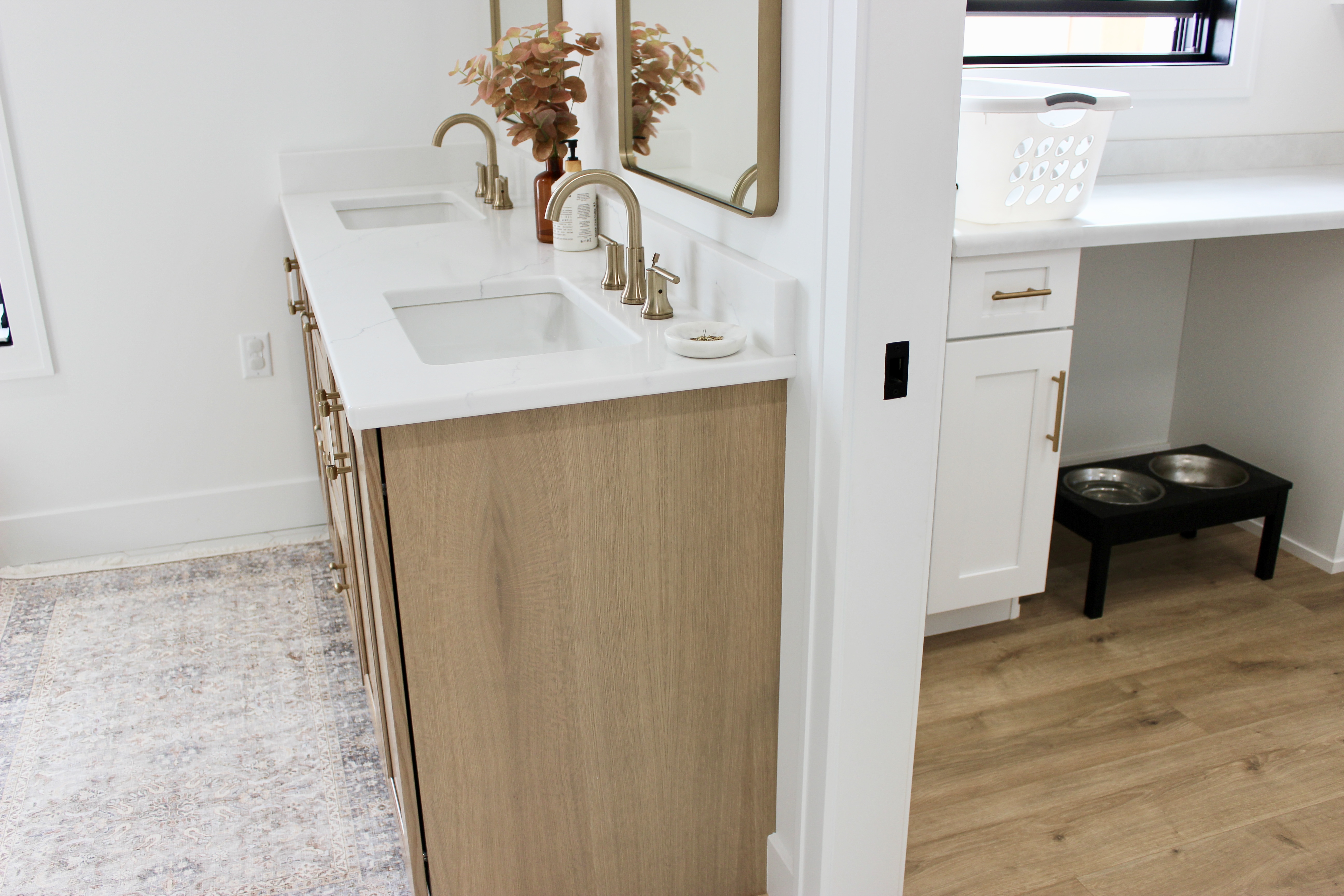 image of doorway showing oak bath vanity cabinet and laundry room off bathroom