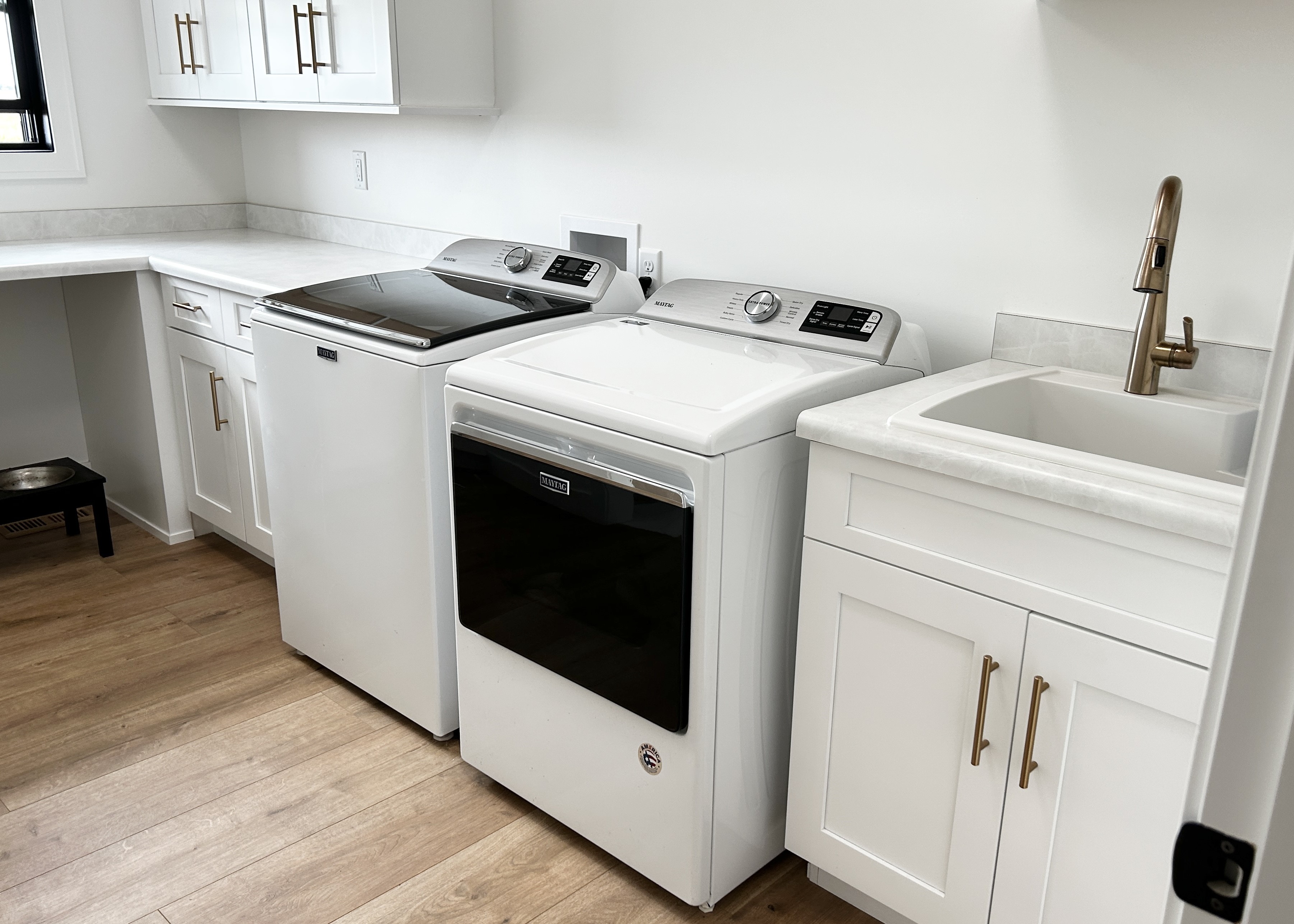 white maytag washer and dryer laundry in laundry room by village home stores