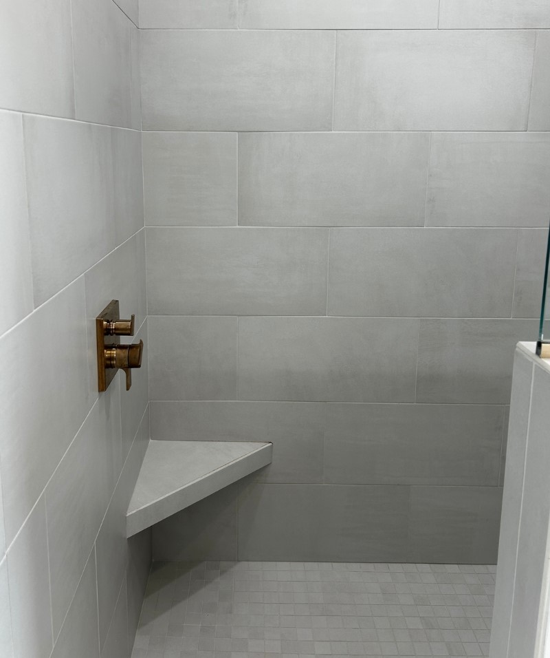 gray tiled shower tile with corner knee ledge shelf