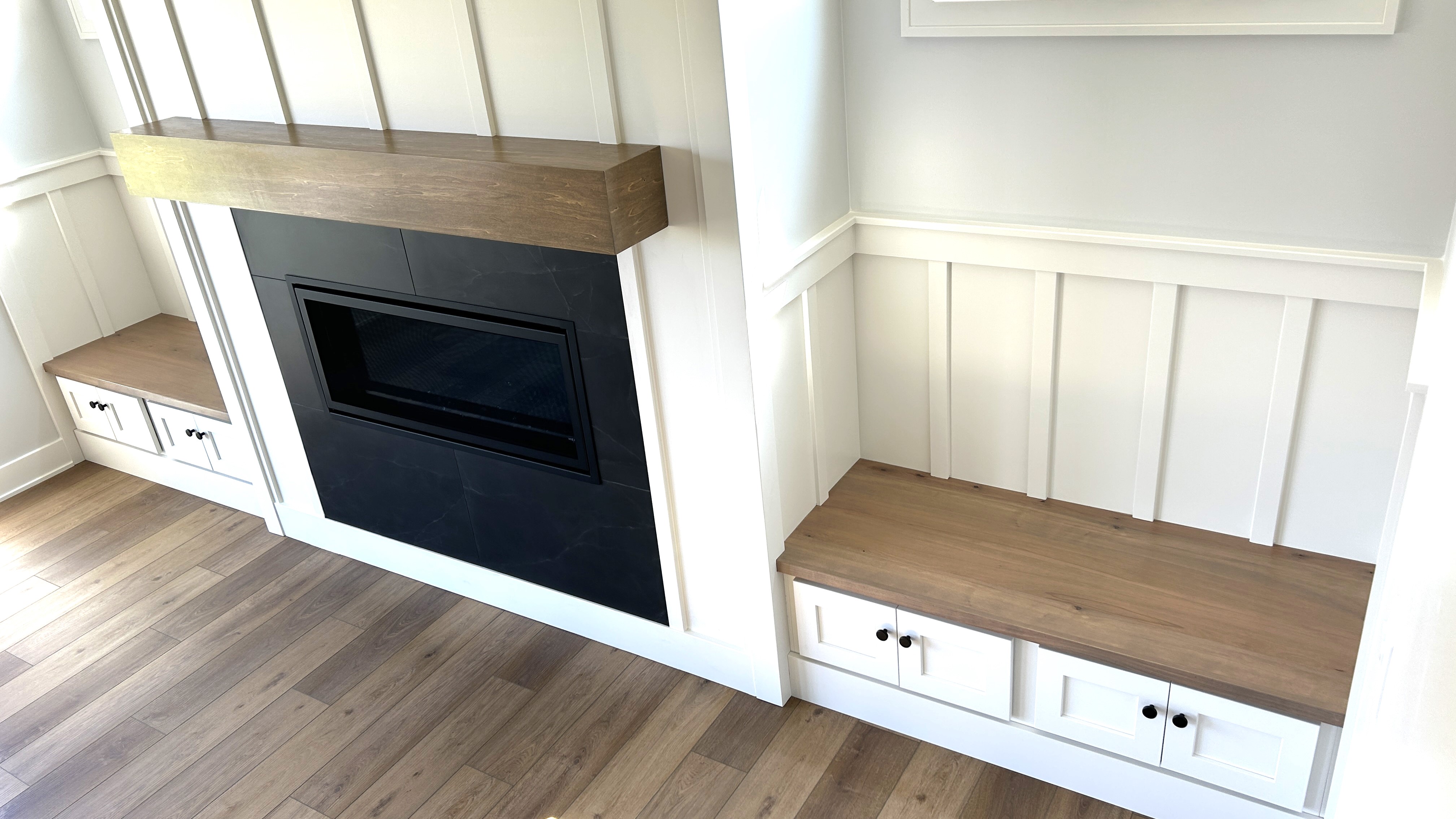 fireplace bench seats in Shoji White paint with Rustic Beech wood tops stained almond to match the kitchen