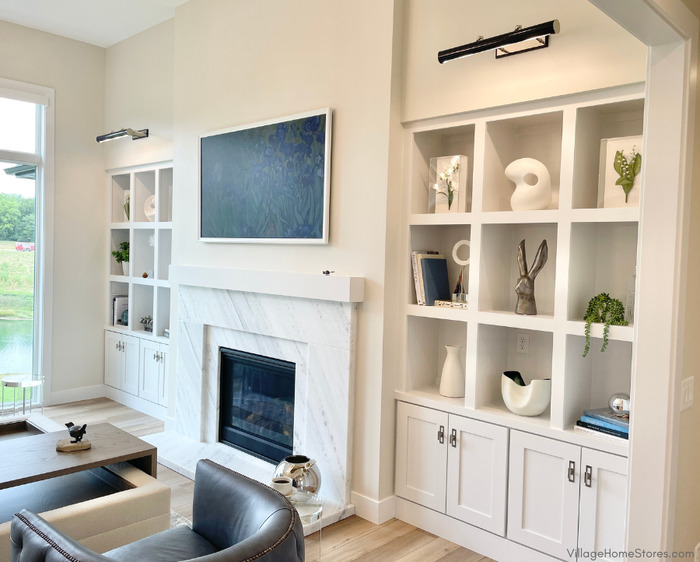 white built in cabinets and shelves bookend a stone fireplace surround with florida wave quartzite