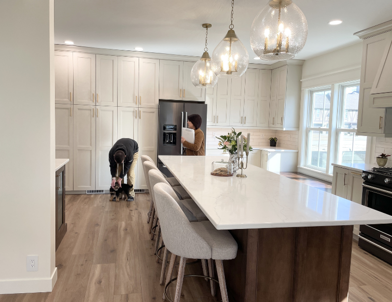 finished kitchen image with large island and tall pantry cabinets