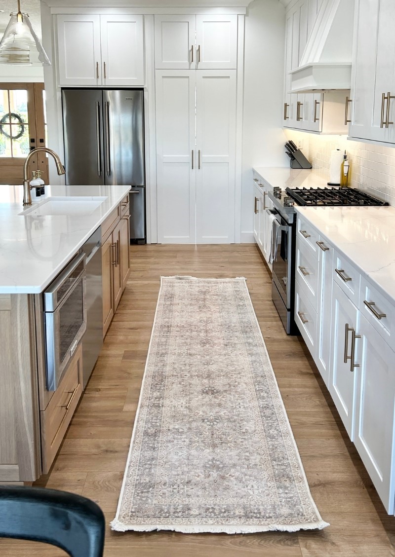 white cabinet and white oak kitchen island design in new home