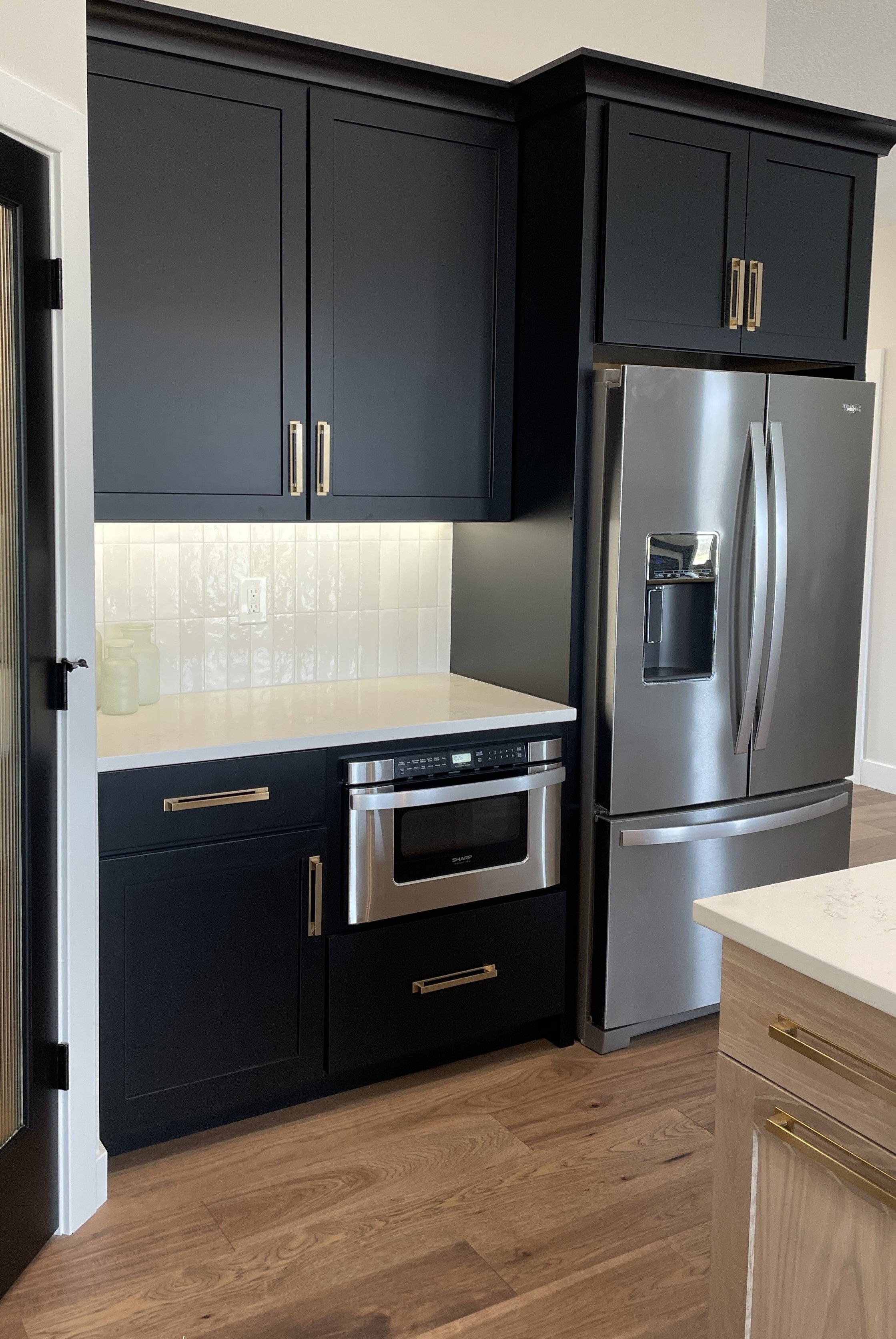 black painted cabinetry in Bettendorf iowa kitchen by village home stores