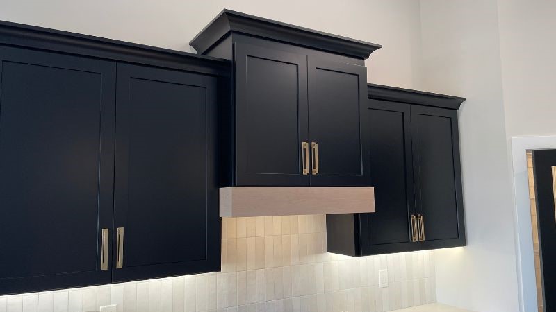 black painted wood hood cabinet with white oak accent banding