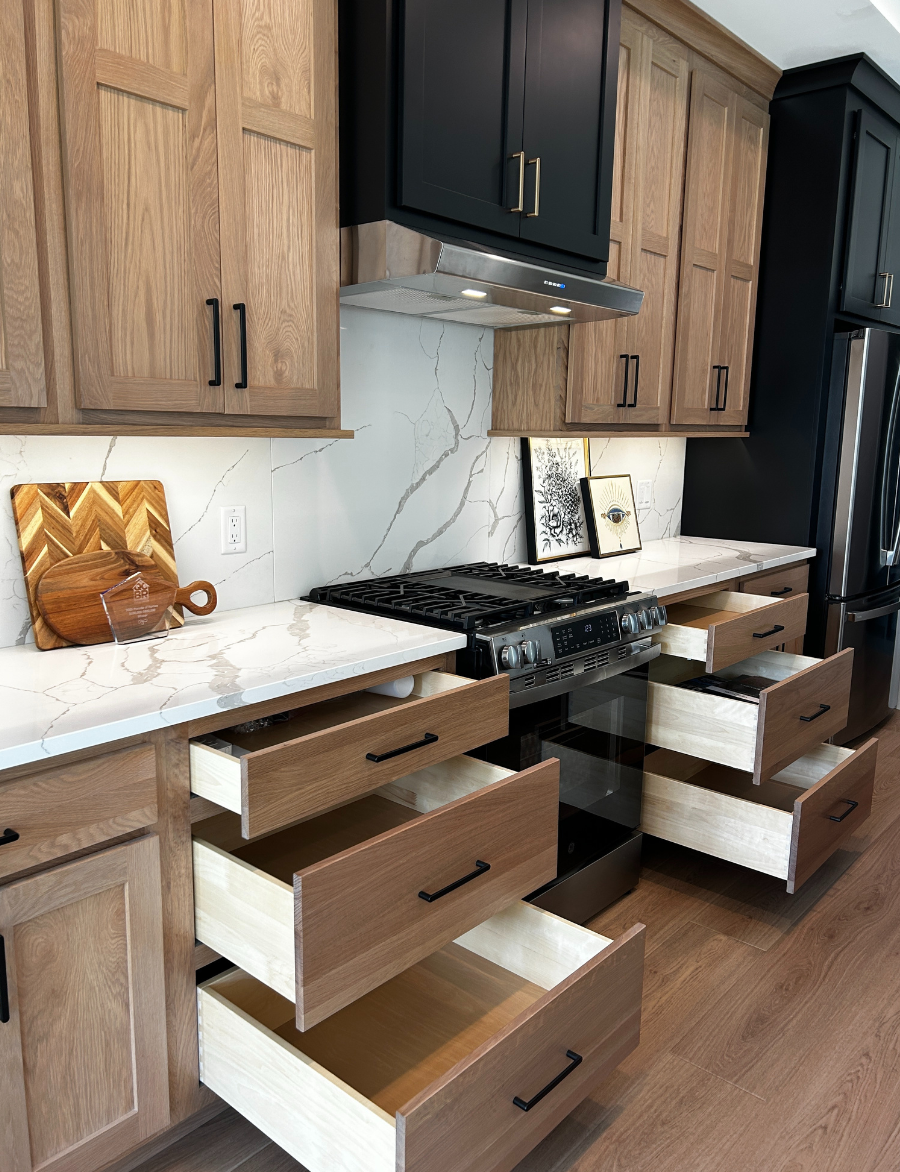 kitchen design with large base cabinet drawers shown open on each side of range