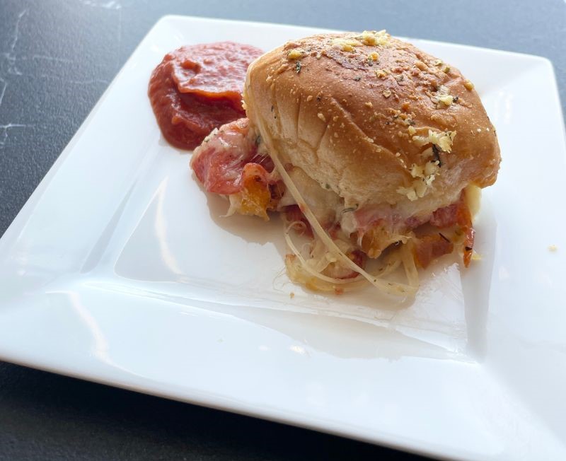 white square plate with peperoni pizza slider and marinara sauce