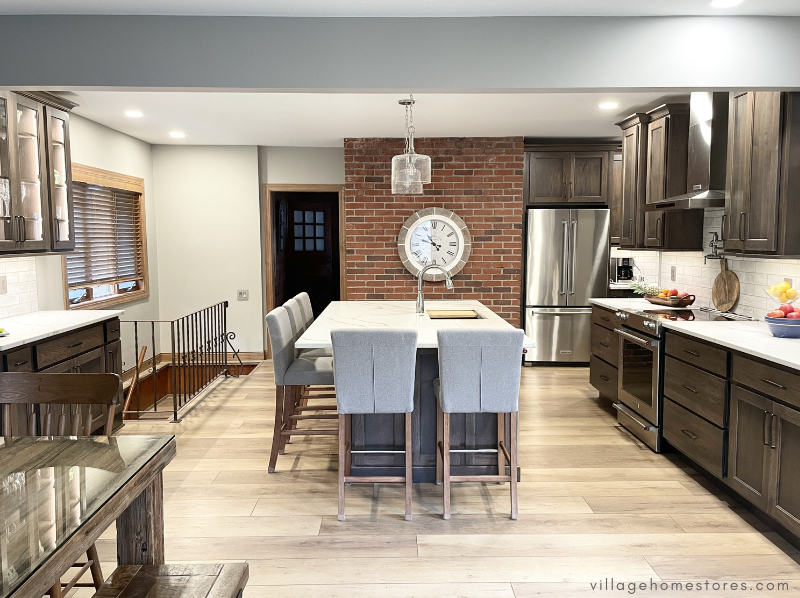 kitchen remodel design from village home stores with brick wall and large island after wall has been removed