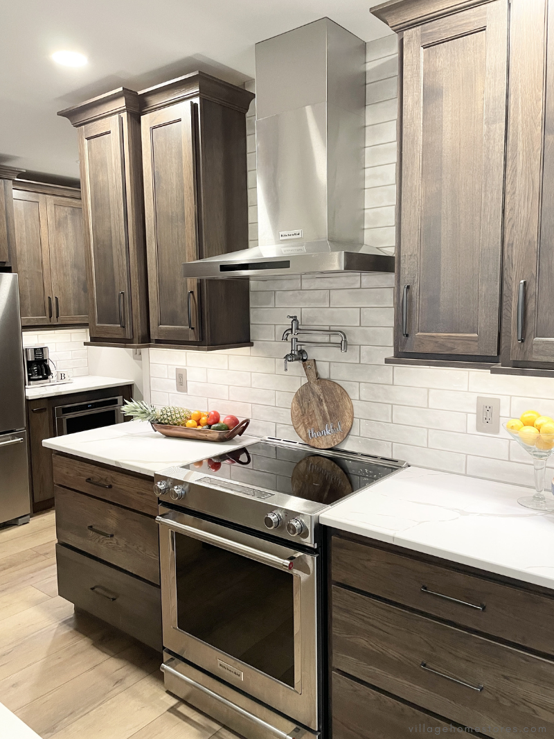 kitchenaid cooking appliances showing electric range and stainless range hood