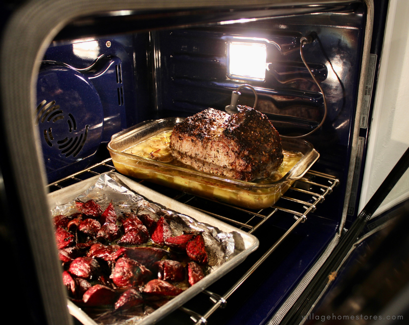 oven with roast and roasted beets in it