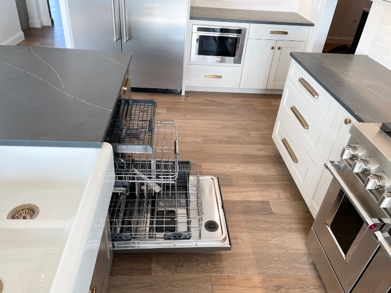 kitchen island pathway with dishwasher in island and door shown open