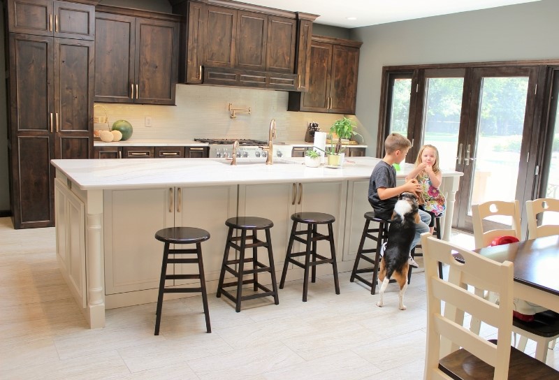 large kitchen island with seating with kids and dog at stools