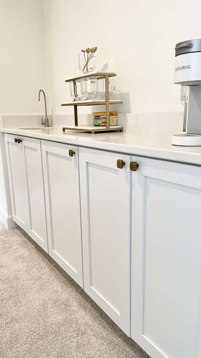 white cabinet coffee bar area in primary suite