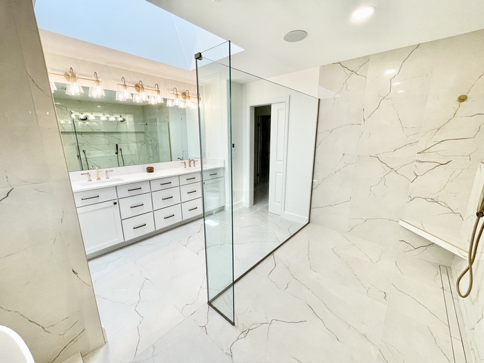 quad cities bathroom image with tiled shower and glass panels and vanity