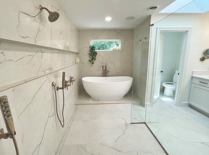 tiled wet room shower with tub deck and white modern bathtub beneath window