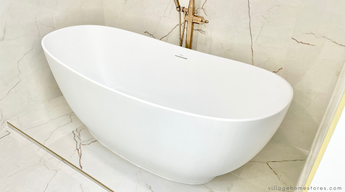 white bathtub on tiled tub deck