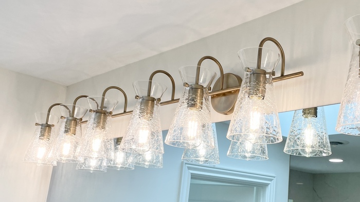 vanity lighting with gold brushed brass metal finish and crackled glass shades