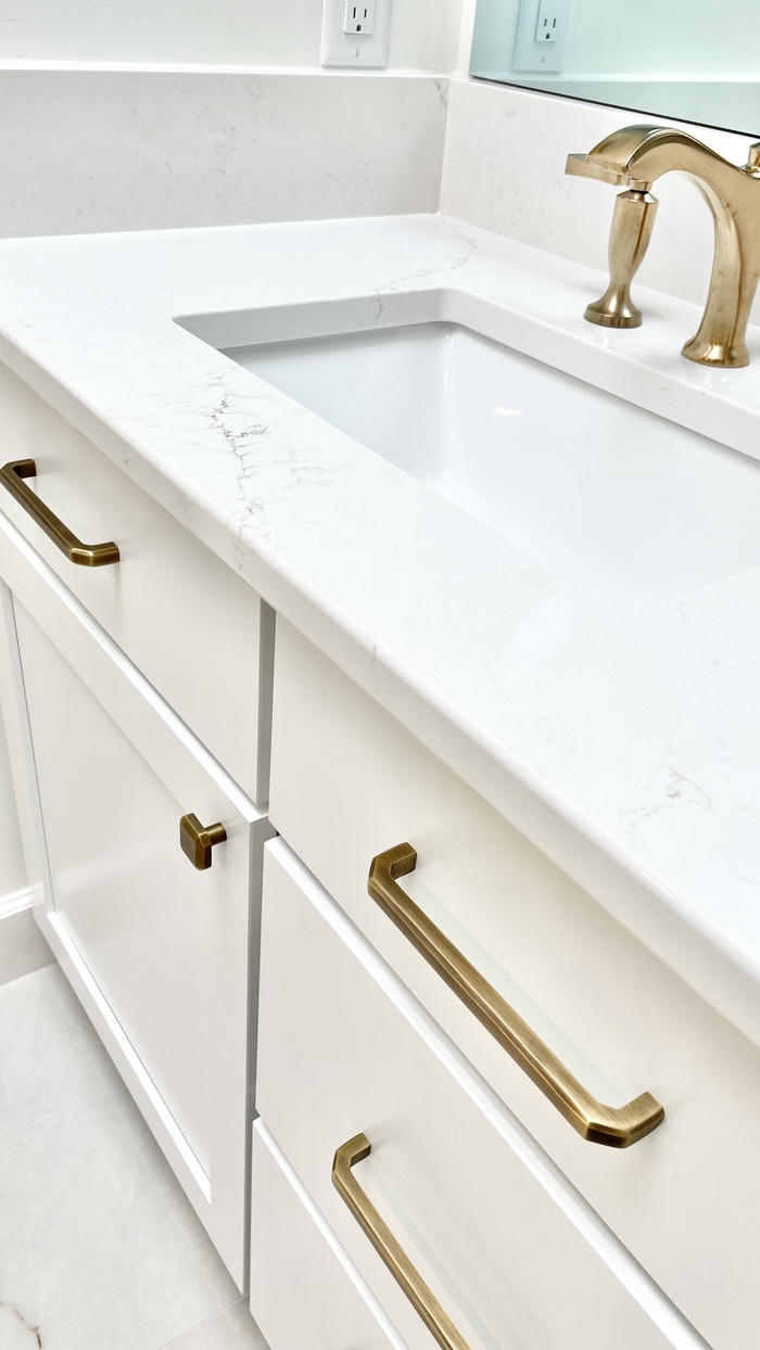 white cabinet closeup show with quartz vanity top