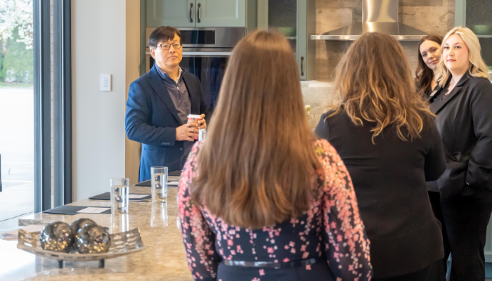 bekins team talking with Sam Kim, president of LG's Home Appliances, in Bekins showroom