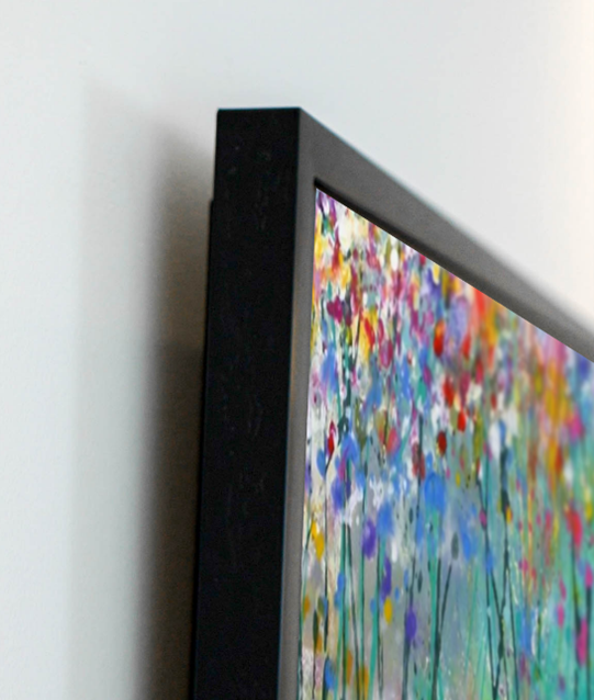 a Samsung The Frame TV mounted on a wall.