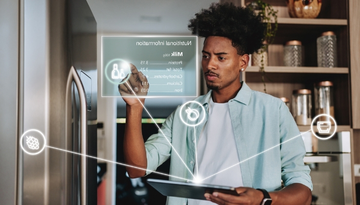 A man goes through the nutritional information for milk from his AI fridge.