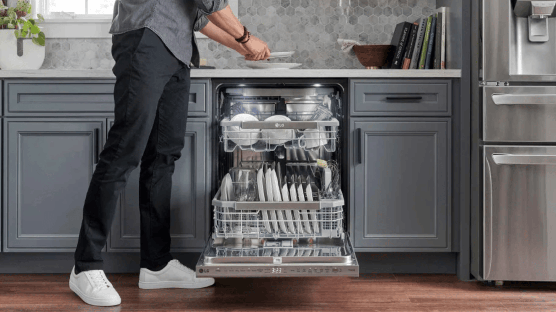 man with open dishwasher