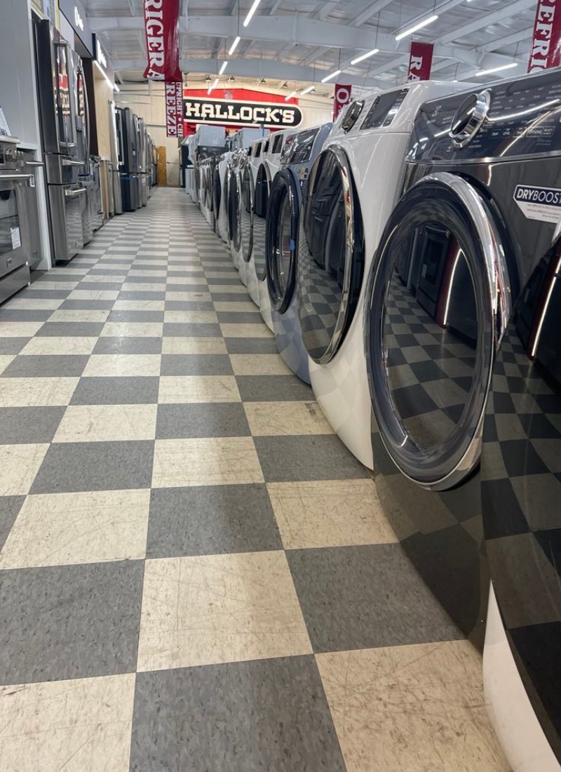 Interior shot of a row of washing machine on a salesfloor.