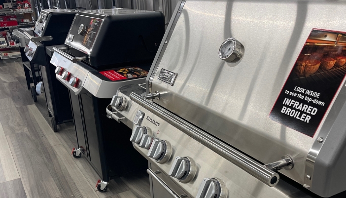 A showroom floor of grills side-by-side.
