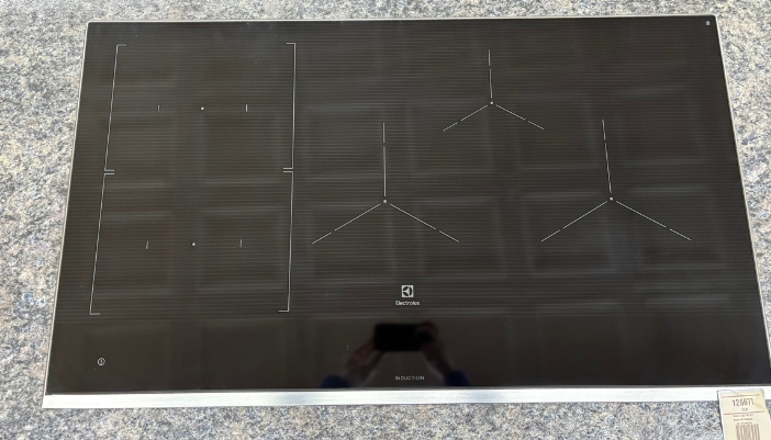 A closeup of a cooktop in a showroom.