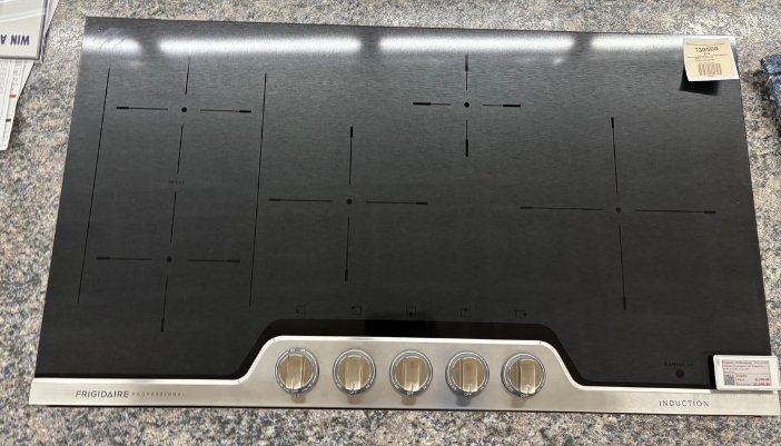 A closeup of a cooktop in a showroom.