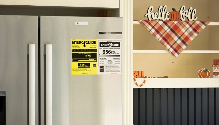 A close-up of an Energy Guide sticker on a stainless steel refrigerator.