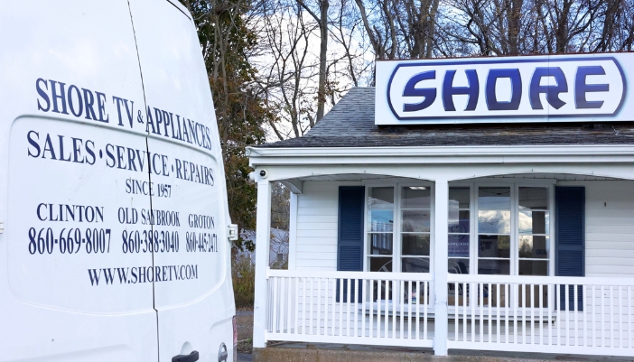 An exterior shot of Shore TV and Appliance with a white van outside as well.