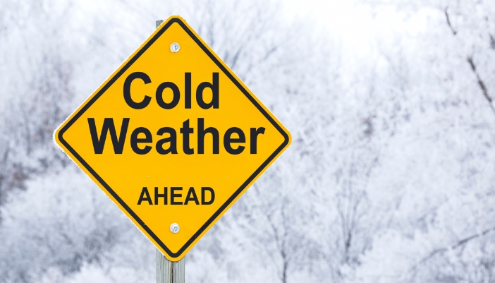 A street sign that says Cold Weather Ahead outdoors.