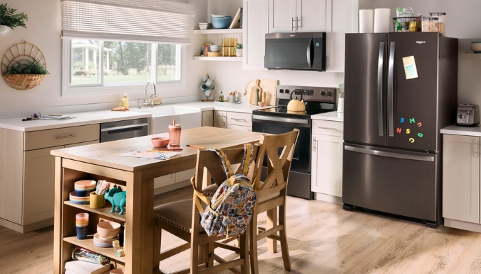 A modern kitchen with black appliances and natural accents.